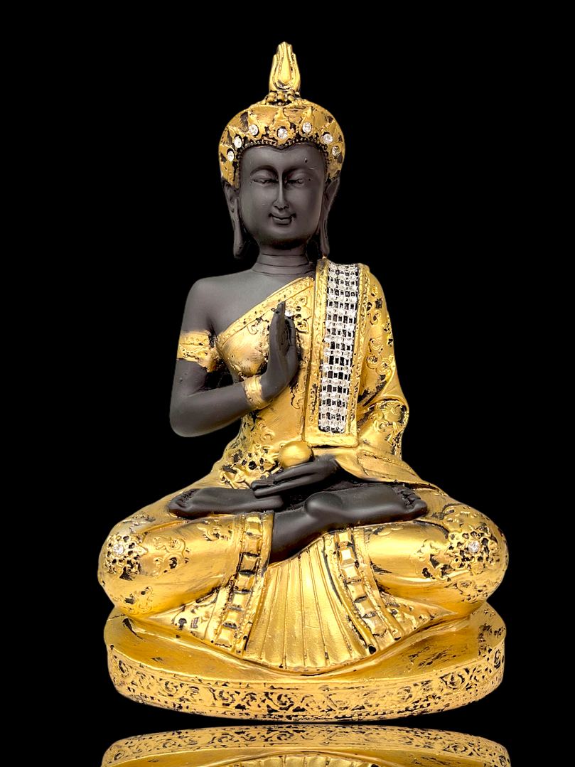 Gold crystal studded Buddha sitting in meditation pose