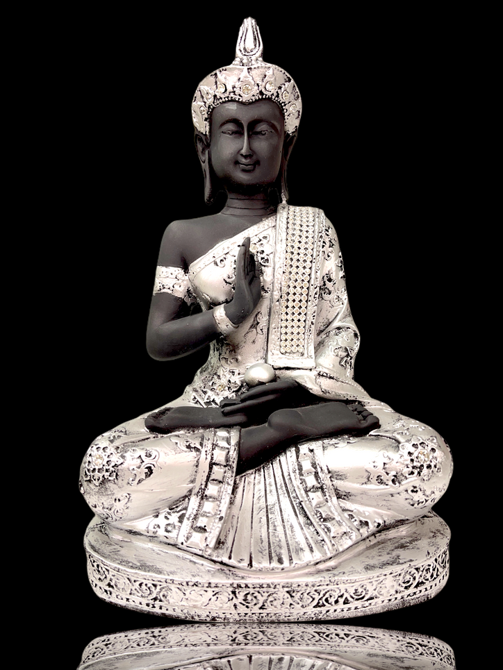 Silver crystal studded buddha sitting in meditation pose