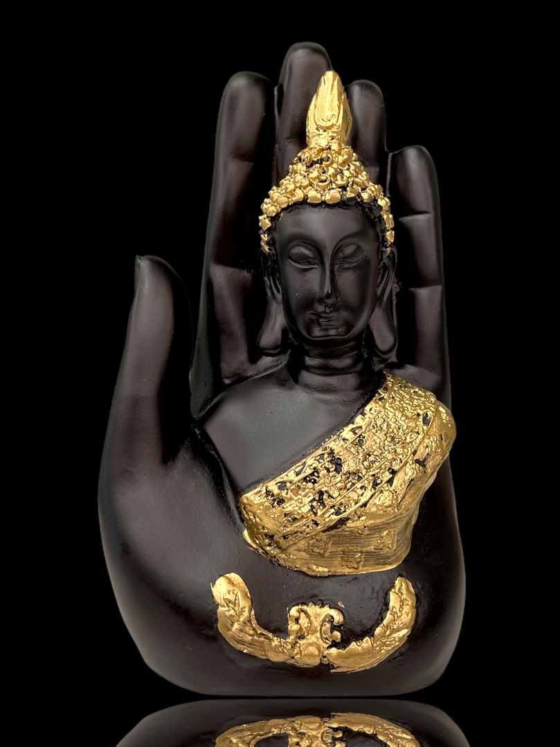 Gold/blue buddha in palm