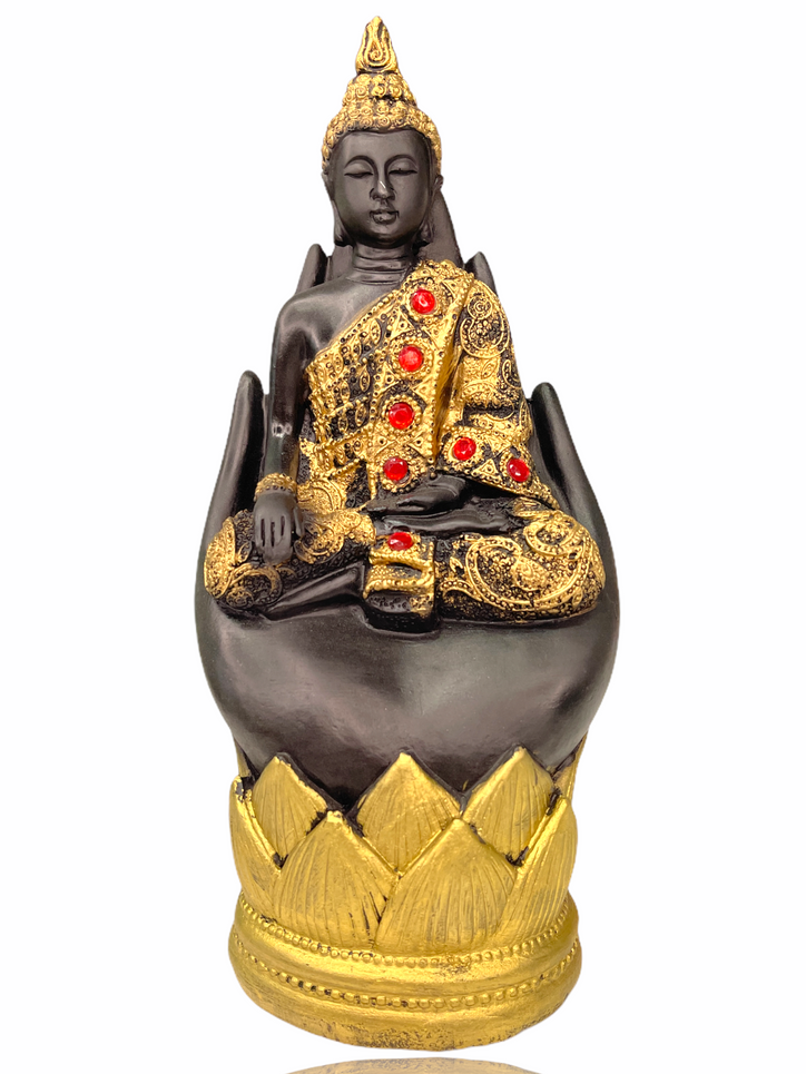 Gold gem studded buddha in palm