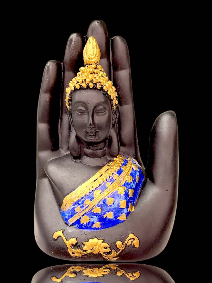 Gold/blue buddha in palm