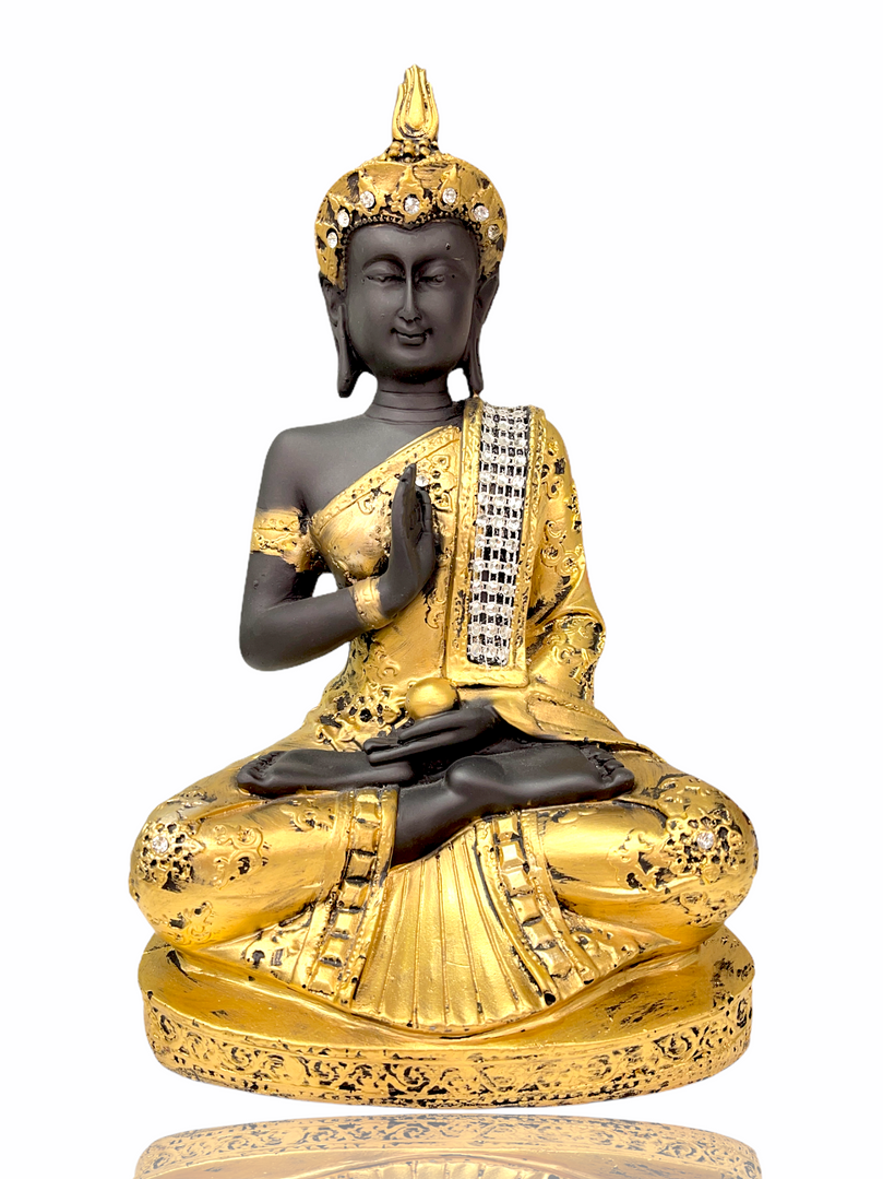 Gold crystal studded Buddha sitting in meditation pose