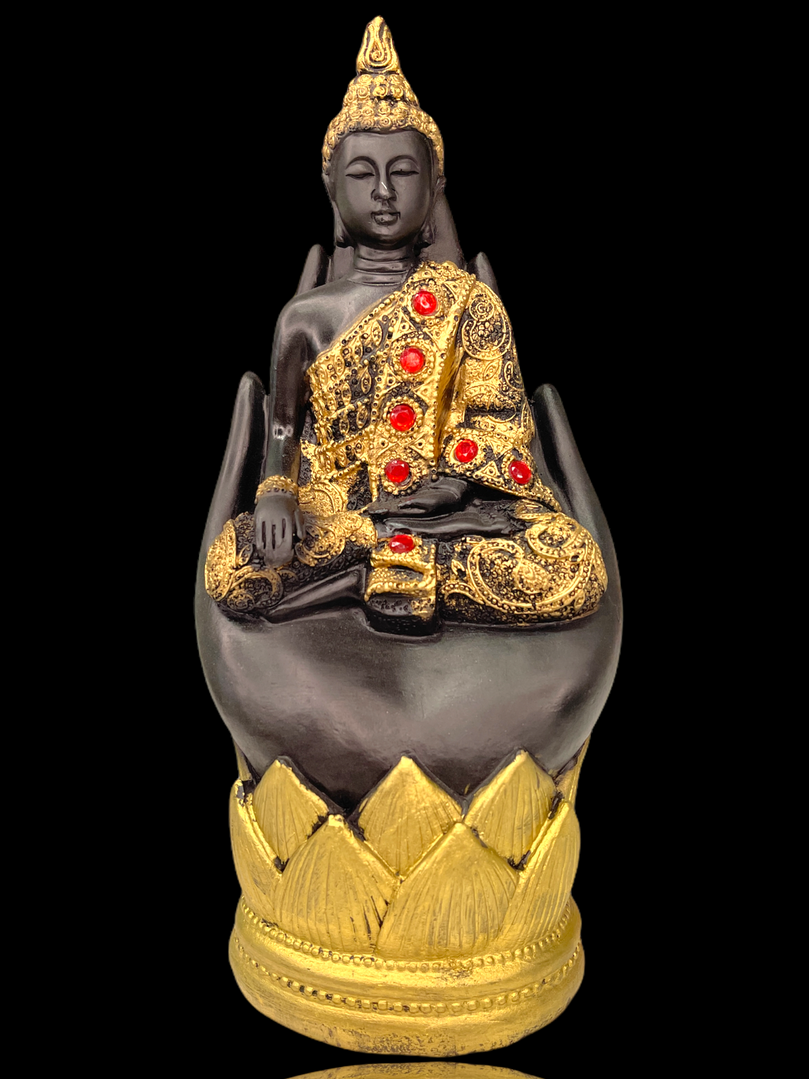 Gold gem studded buddha in palm